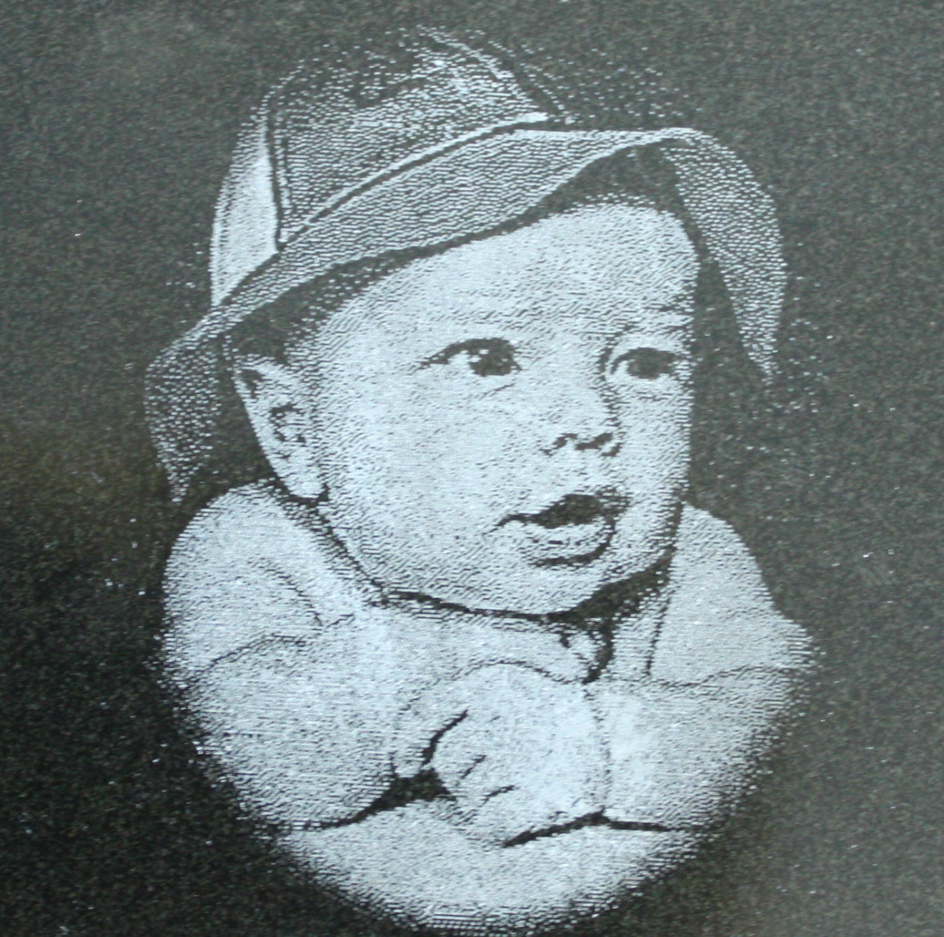 Cute baby etched in black granite.
