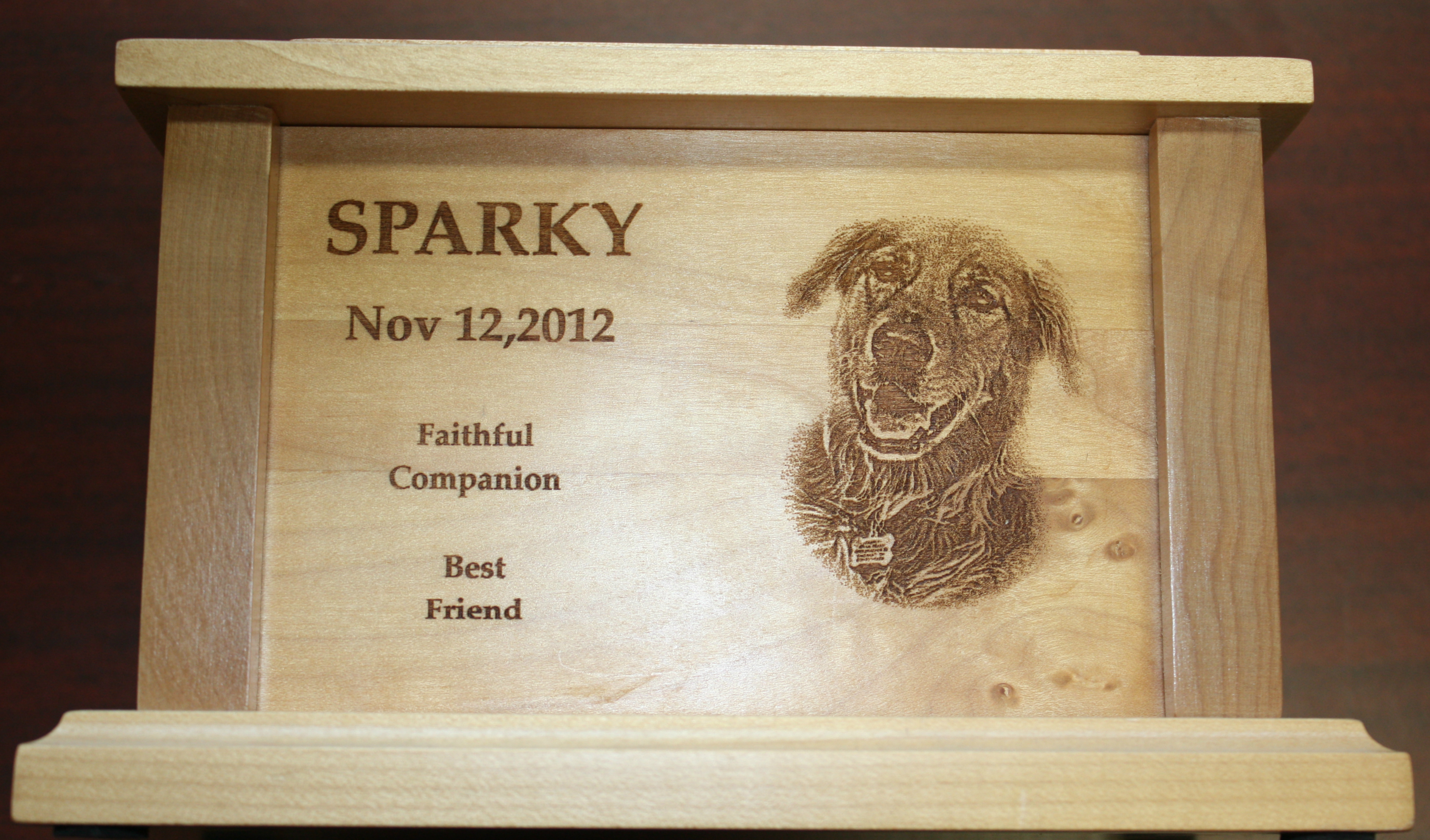 An urn for a doggo, laser etched wood.